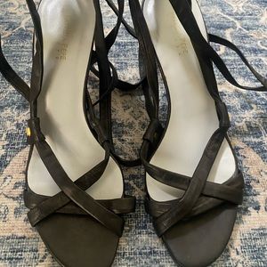 Black leather Patricia Pepe wrap up heels with gold medallion end of the strap